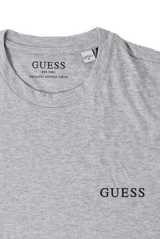 Maglietta Guess Jeans per uomo in cotone grigio con logo stampato, maniche corte e taglio dritto. Comfort e stile per ogni occasione.